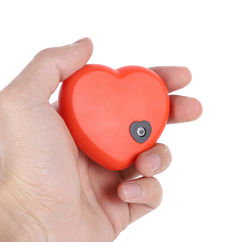 Removable red heart-shaped heartbeat module with power button